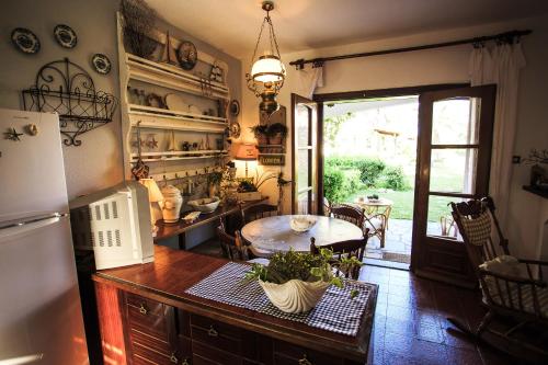 a kitchen with a refrigerator and a table and a dining room at Seaside Mikiverna Cozyhome in Kalyves Poligirou