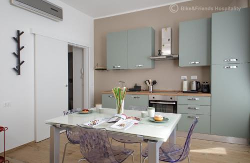 a kitchen with a white table and chairs at CASA CAMILLA in Pesaro