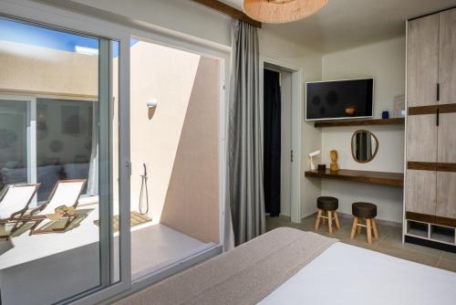 a bedroom with a bed and a sliding glass door at The Hydor Element Of Gaea in Loutrá
