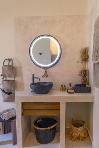a bathroom with a sink and a mirror on the wall at The Hydor Element Of Gaea in Loutrá