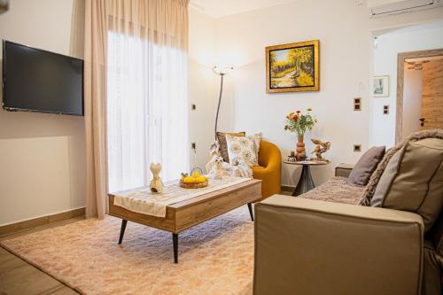 a living room with a couch and a coffee table at Myrtilli Cottages Pelion in Áno Lekhónia