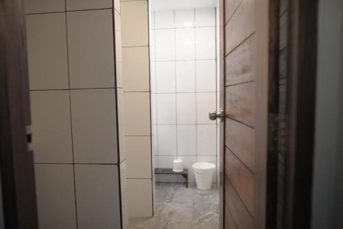 an open door to a bathroom with a toilet at KENCOZY accommodation in Bangkok
