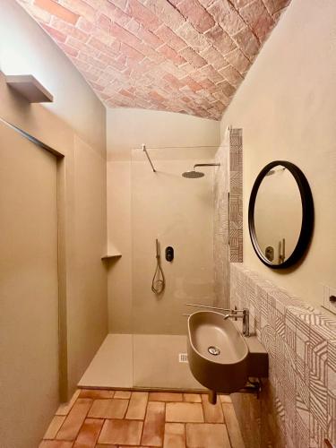 a bathroom with a sink and a mirror at Relais Dal Cavaliere in Castellino
