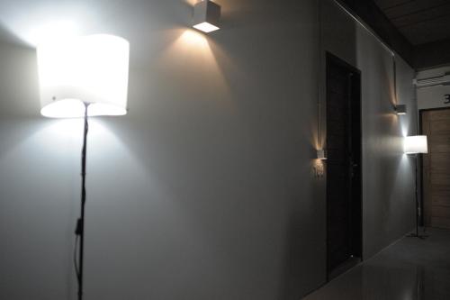 a room with two lights on a white wall at KENCOZY accommodation in Bangkok