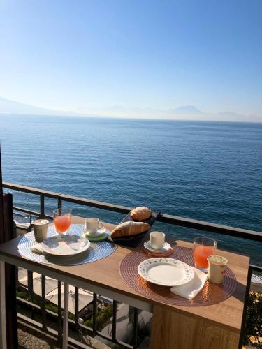 a table with food and a view of the ocean at B&B Vista Mare in Naples