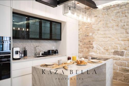 a kitchen with a table with bread on it at KAZA BELLA - Haut Marais Modern flat with small pool in Paris