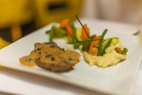 a plate of food with vegetables on a table at Hotel Vents Des Iles in Essaouira