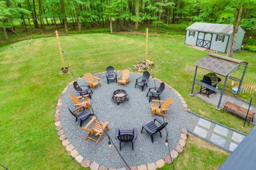 an aerial view of a patio with tables and chairs at 5 Mi to Lake Naomi Home with Hot Tub and Fire Pit in Long Pond