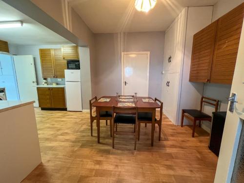 a kitchen with a table and chairs in a room at Mountain View in Skreen
