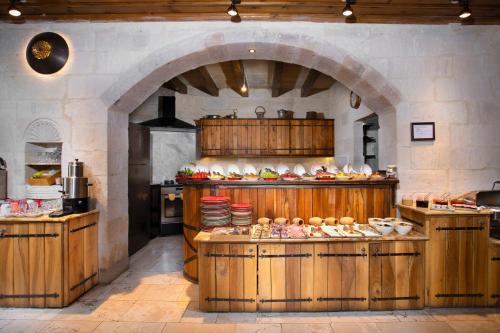 a large kitchen with a buffet of food on display at Terra Cave Hotel in Goreme