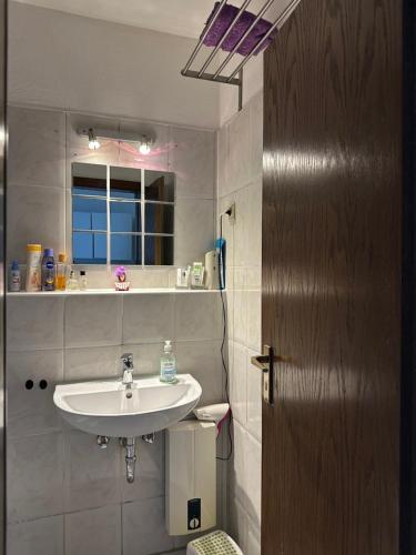 a bathroom with a sink and a window at Jasmin’s Apartment in Krefeld