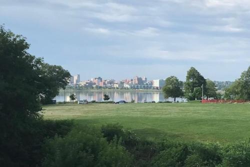 a park with a lake and a city in the background at Top Deck Portland Property with Views in Portland