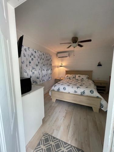 a bedroom with a bed and a ceiling fan at Kings Kamp in Key Largo