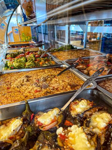 a buffet filled with different types of food at The Blue House in Loutro