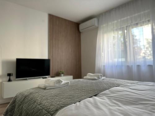 Postel nebo postele na pokoji v ubytování Milty Apartments