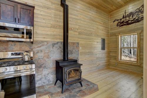 a stove in the kitchen of a log cabin at Amethyst Hideaway in Creede