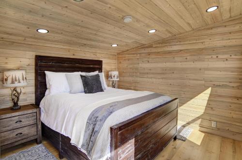 a bedroom with a bed in a wooden cabin at Amethyst Hideaway in Creede