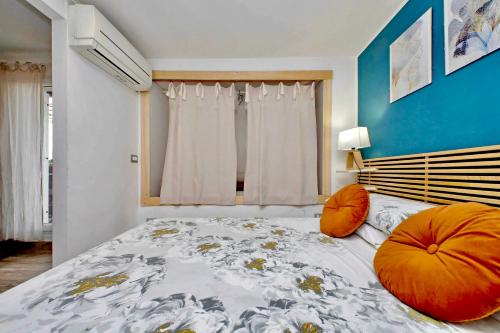 a bedroom with a bed with orange pillows on it at The Attic in Civitavecchia