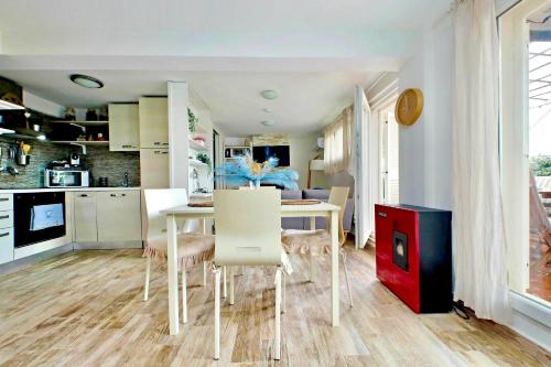a kitchen and dining room with a table and chairs at The Attic in Civitavecchia