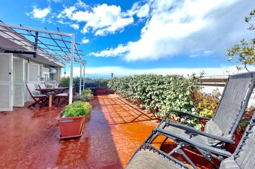 a patio with chairs and plants on a house at The Attic in Civitavecchia