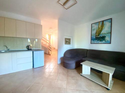 a living room with a couch and a table at Christopher's apartments in Ulcinj