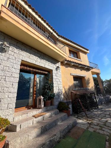 a house with stairs leading up to a building at Venti di Vacanza - Levante & Grecale in Olbia
