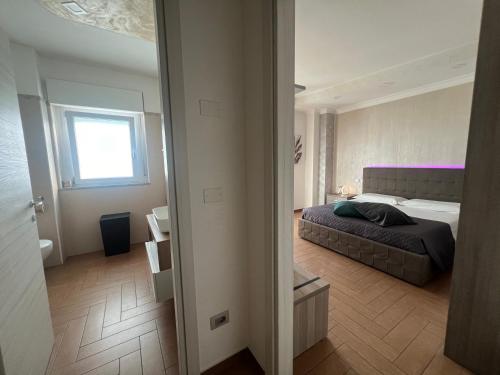 Ένα ή περισσότερα κρεβάτια σε δωμάτιο στο B&B Palazzo del Toro