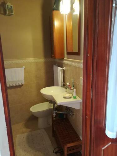 a bathroom with a sink and a toilet at Casa Castel del Monte in Castel del Monte