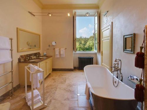 a large bathroom with a tub and a sink at Hotel Villa Casanova in Lucca