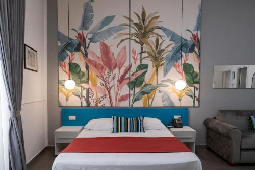 a bedroom with a bed with a painting on the wall at Hotel San Michele in Naples