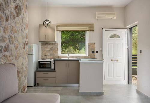 a kitchen with a sink and a white door at Irene Studios in Pefki