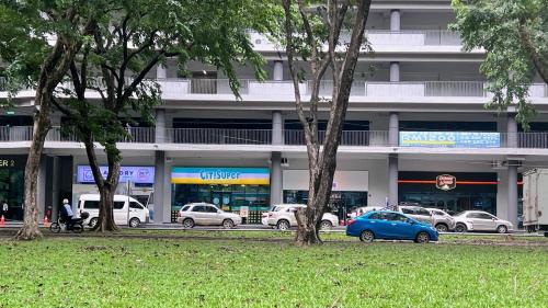 a parking lot with cars parked in front of a building at JQ Unity Homestay 2 High Floor Seaview Netflix 6pax in Kota Kinabalu