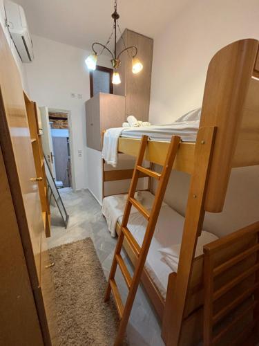 a small room with a bunk bed and a ladder at Vilitsa Holiday House in Pyrgi