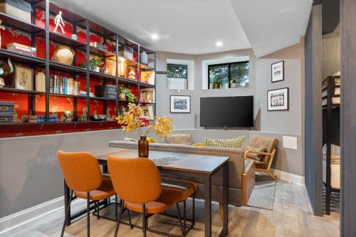 a dining room with a table and chairs and a tv at Wrigleyville Suites in Chicago