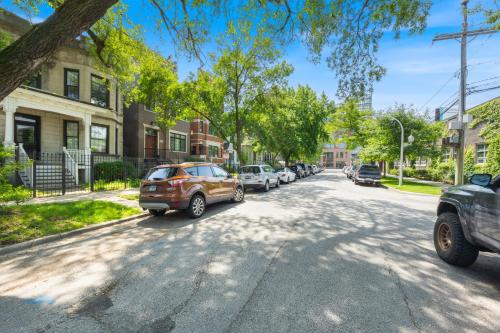 a street with cars parked on the side of the road at Wrigleyville Suites in Chicago