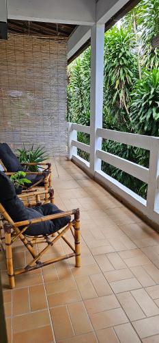 a room with chairs and plants on a patio at Sunset Flats - Aconchengante Flat na Rua Pituba bem perto das Praias Urbanas! Itacare BA - PIT 1 in Itacaré