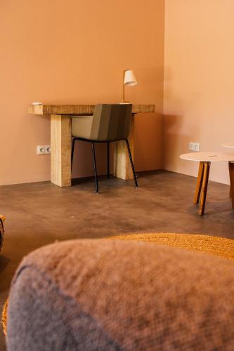 a table and a chair in a room at Naturescape Villa Bliss - Sint Michiel in Sint Michiel