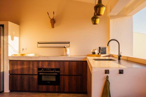 a kitchen with a sink and a stove at Naturescape Villa Bliss - Sint Michiel in Sint Michiel