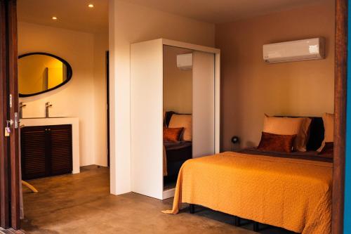 a bedroom with a bed and a mirror at Naturescape Villa Bliss - Sint Michiel in Sint Michiel