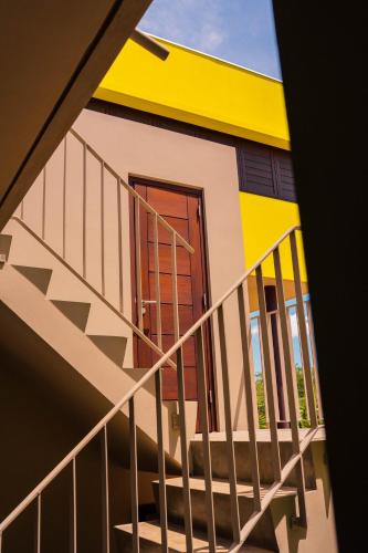 a staircase leading up to a house with a yellow at Naturescape Villa Bliss - Sint Michiel in Sint Michiel