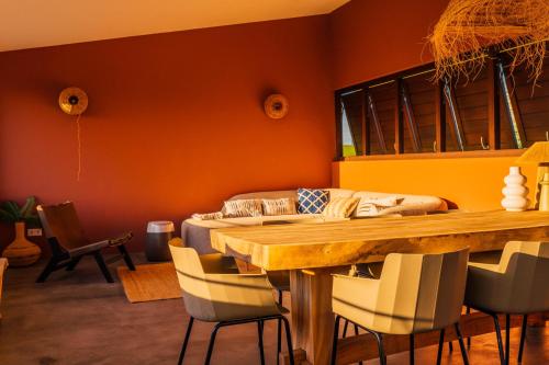 a dining room with a wooden table and chairs at Naturescape Villa Bliss - Sint Michiel in Sint Michiel