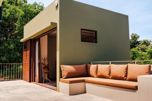a couch sitting on a balcony of a house at Naturescape Villa Bliss - Sint Michiel in Sint Michiel