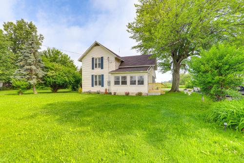 a white house with a large yard at Welcoming Port Clinton Vacation Rental! in Port Clinton
