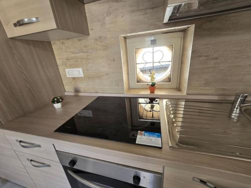 a kitchen with a sink and a window in it at Perla -Centro Storico Vasto- in Vasto