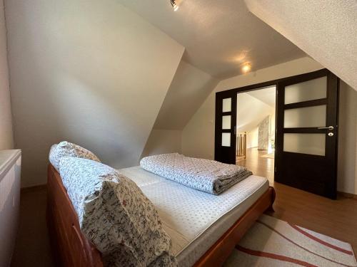 a bedroom with a bed in a attic at Chalupa u Vojvodovcov in Zázrivá