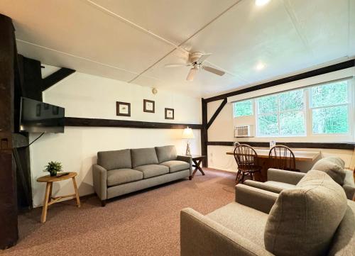 a living room with a couch and a table at Mountain Springs Lake Resort in Stroudsburg
