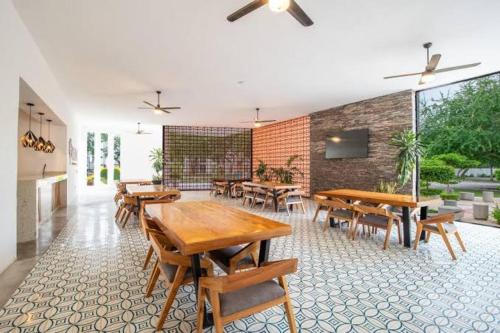 a dining room with wooden tables and chairs at for in Puerto Vallarta
