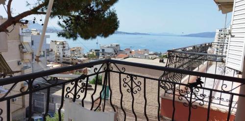 a balcony of a building with a view of the water at Elena Apartament in Sarandë