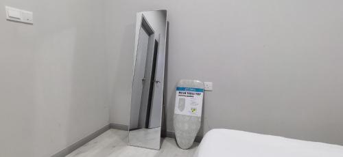 a room with a mirror and a radiator in a wall at JQ Unity Homestay 2 High Floor Seaview Netflix 6pax in Kota Kinabalu