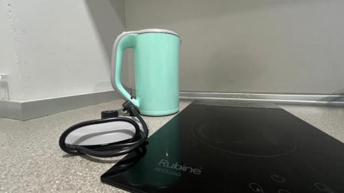a black and green appliance sitting on a counter at JQ Unity Homestay 2 High Floor Seaview Netflix 6pax in Kota Kinabalu